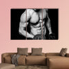 Young strong athlete on dark background isolated Multi panel canvas wall art