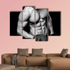 Young strong athlete on dark background isolated Multi panel canvas wall art