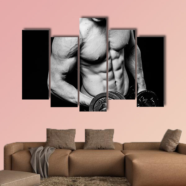 Young strong athlete on dark background isolated Multi panel canvas wall art