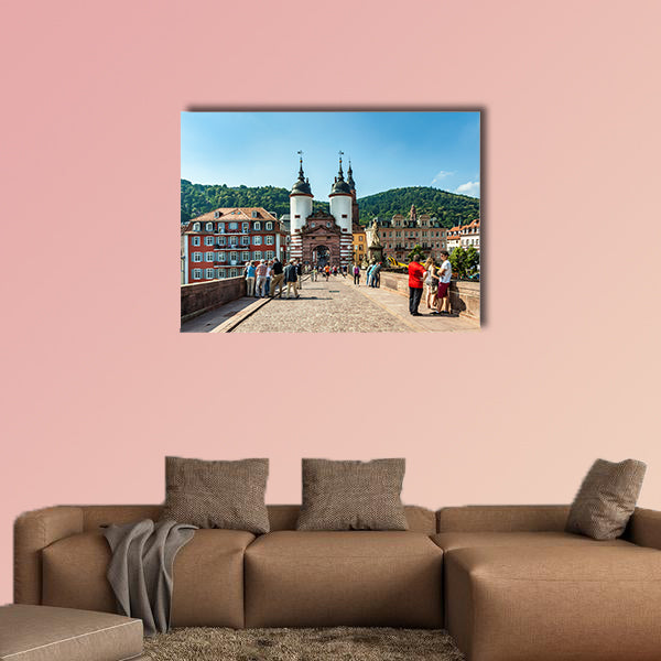 People visit old bridge and town gate in Heidelberg, Germany wall art