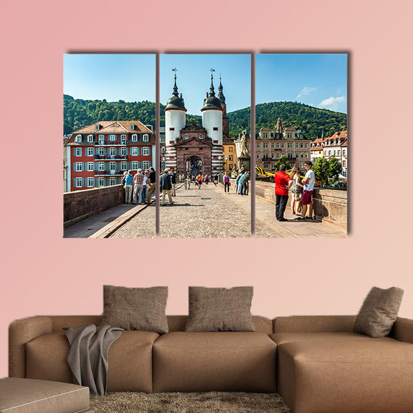 People visit old bridge and town gate in Heidelberg, Germany wall art
