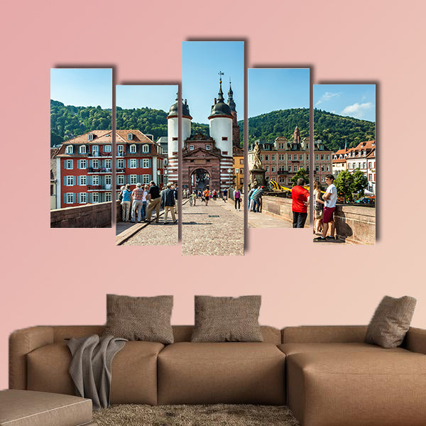 People visit old bridge and town gate in Heidelberg, Germany wall art