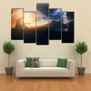 A Man Praying In Front Of The God In A Windy Storm And The Sunrise Multi Panel Canvas Wall Art