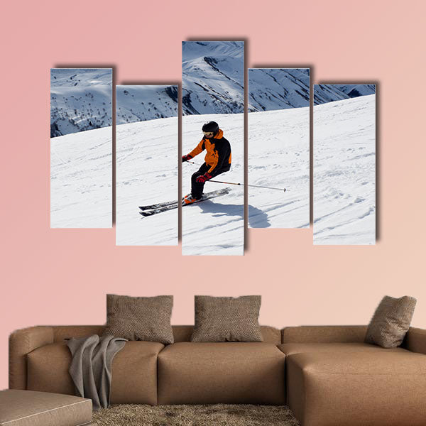 Skier turning down the mountain Multi panel canvas wall art
