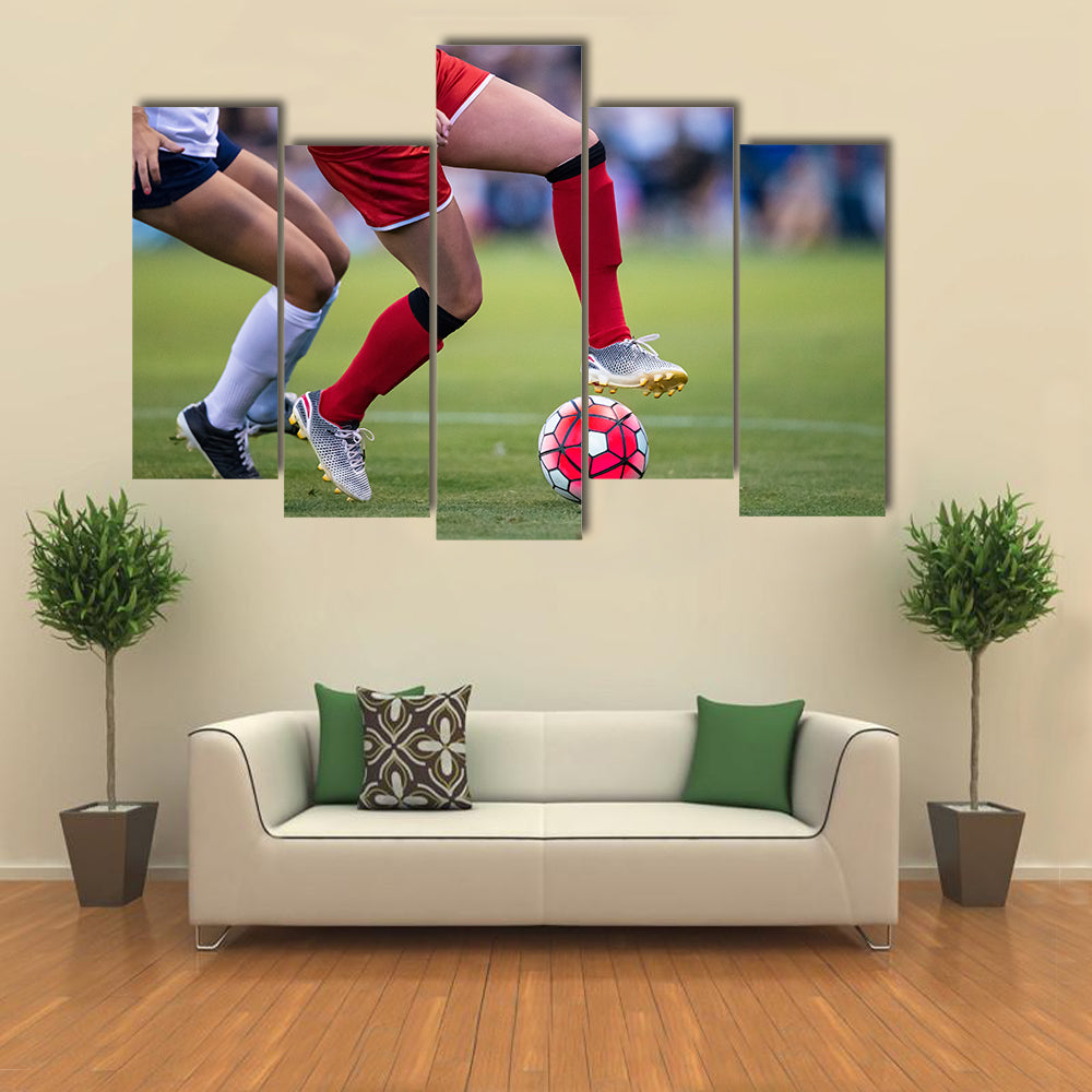 Women playing in a soccer game on a soccer field Multi panel canvas wall art