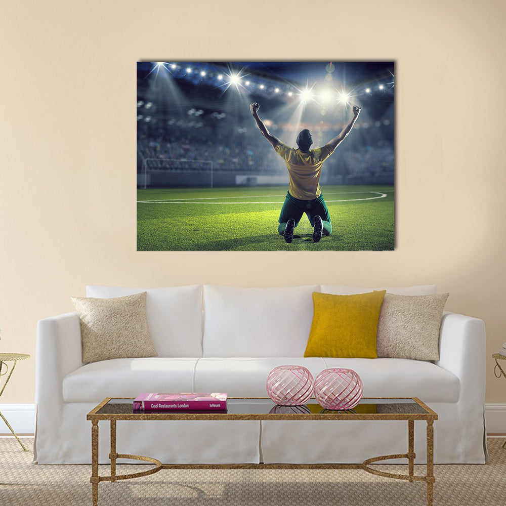 Soccer player celebrating victory while holding win cup Multi panel canvas wall art