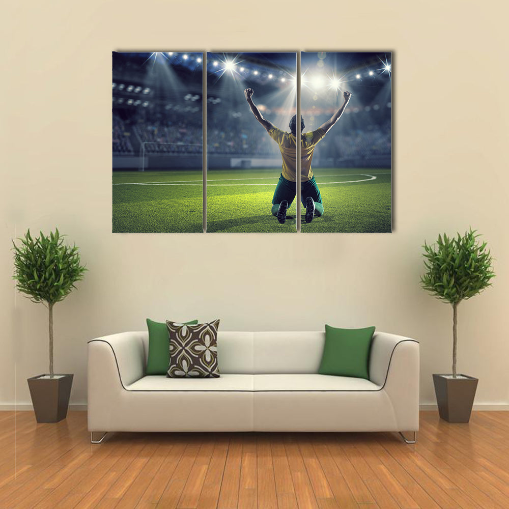 Soccer player celebrating victory while holding win cup Multi panel canvas wall art
