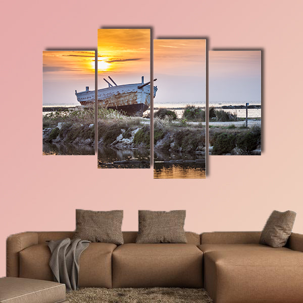 An old and weathered boat at the Sicilian sunset multi panel canvas wall art