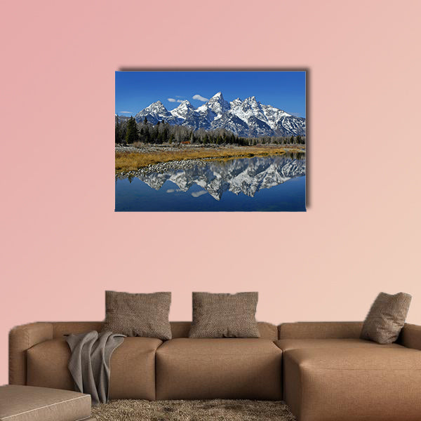 Teton mountain range reflecting in river water with surrounding plants wall art
