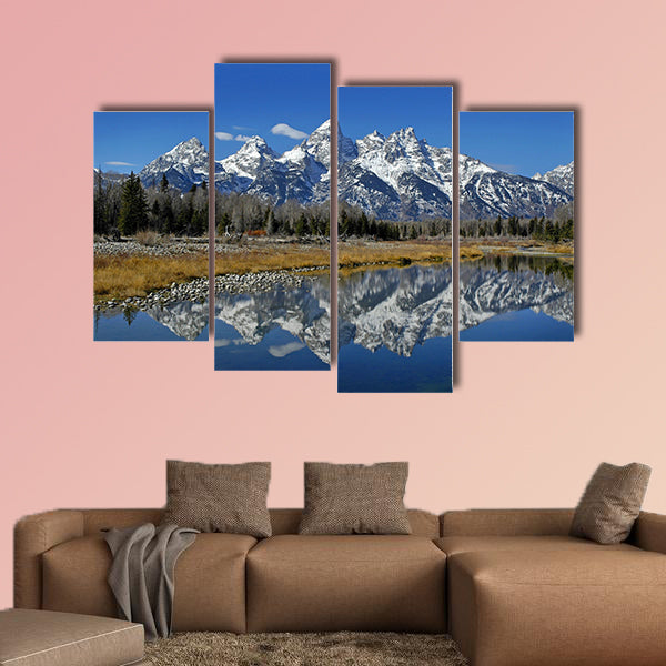 Teton mountain range reflecting in river water with surrounding plants wall art