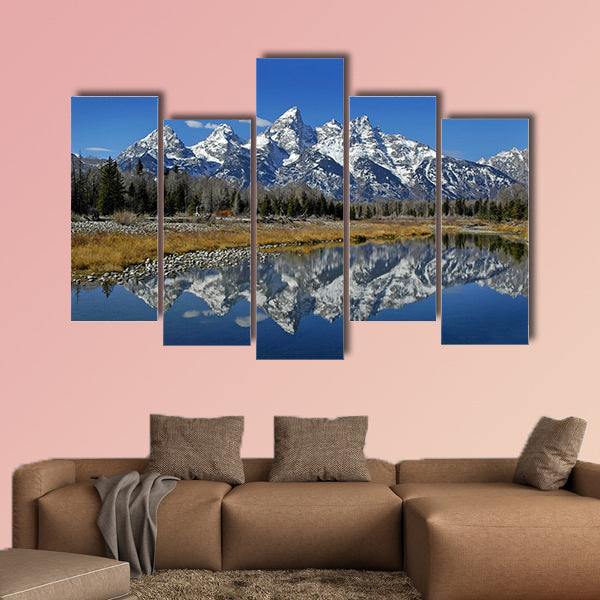 Teton mountain range reflecting in river water with surrounding plants wall art