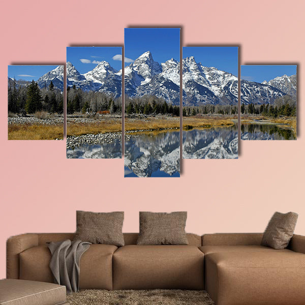 Teton mountain range reflecting in river water with surrounding plants wall art