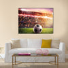 Soccer ball on the lawn of a stadium Multi panel canvas wall art