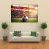 Soccer ball on the lawn of a stadium Multi panel canvas wall art