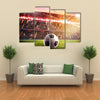 Soccer ball on the lawn of a stadium Multi panel canvas wall art