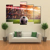 Soccer ball on the lawn of a stadium Multi panel canvas wall art