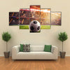 Soccer ball on the lawn of a stadium Multi panel canvas wall art