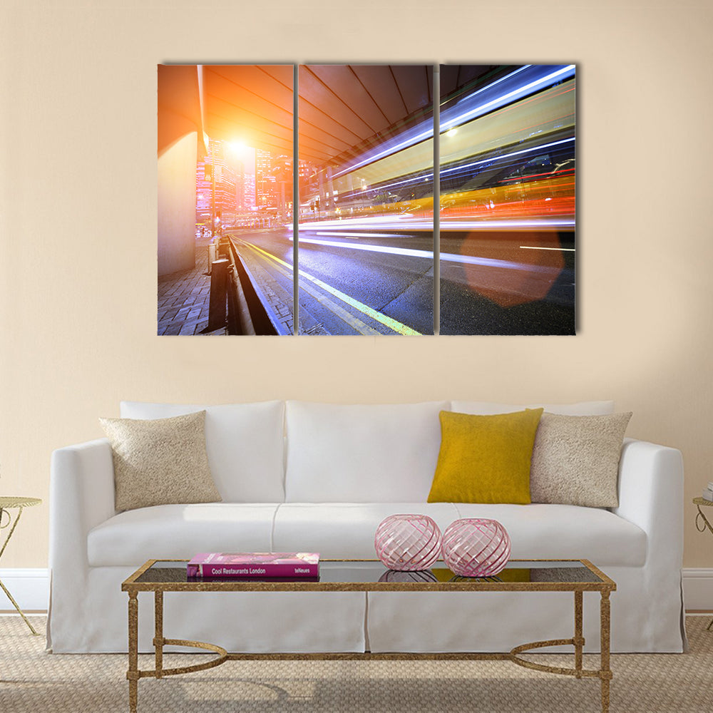Bus speeding through night street. Hong Kong multi panel canvas wall art