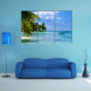 Green palms on a white sand beach with blue sky Multi panel canvas wall art