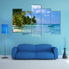 Green palms on a white sand beach with blue sky Multi panel canvas wall art