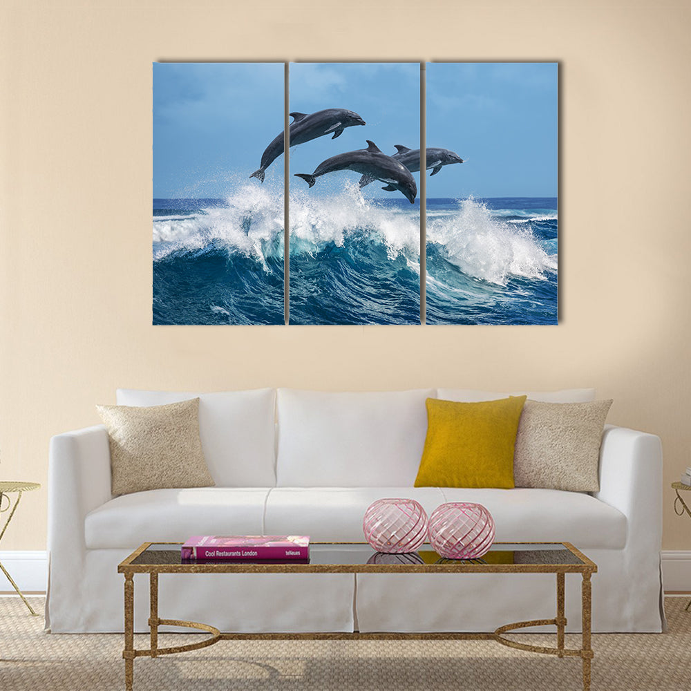 Three Beautiful Dolphins Jumping Over Breaking Waves Multi Panel Canvas Wall Art