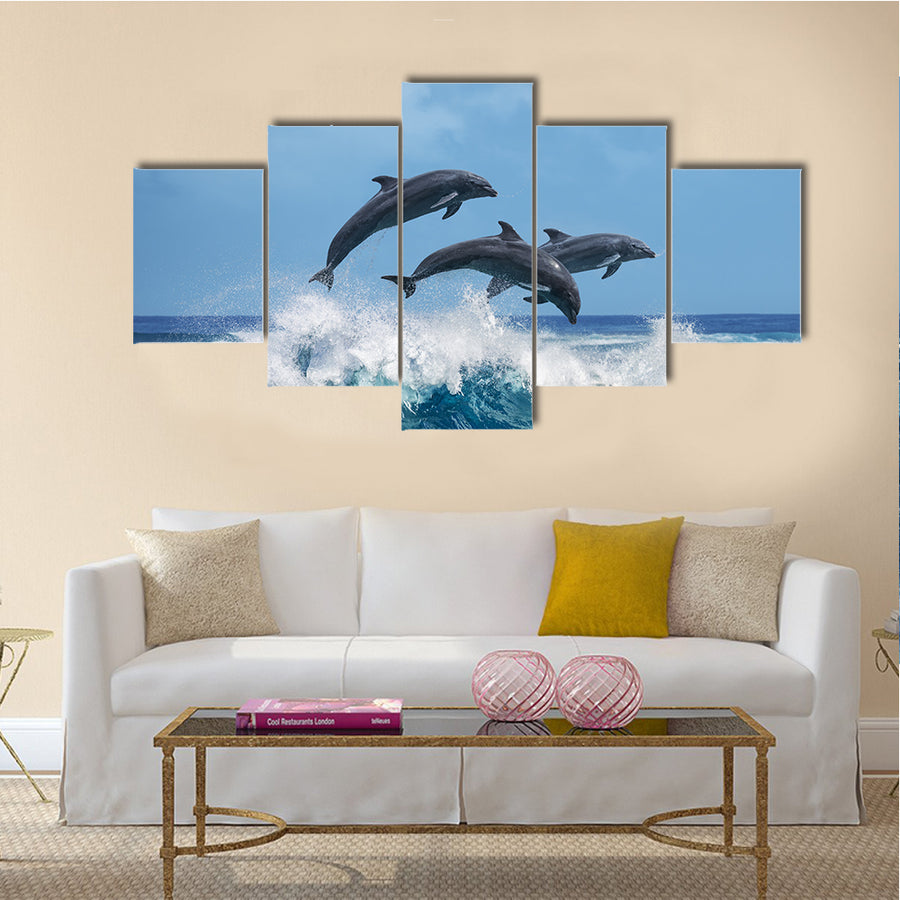 Three Beautiful Dolphins Jumping Over Breaking Waves Multi Panel Canvas Wall Art