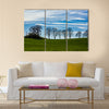 Large trees silhouetted against a blue sky Multi Panel Canvas Wall Art