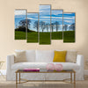 Large trees silhouetted against a blue sky Multi Panel Canvas Wall Art