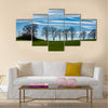 Large trees silhouetted against a blue sky Multi Panel Canvas Wall Art