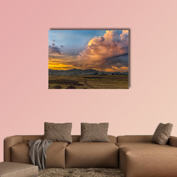 A rural landscape with stormy clouds emerging out of the mountains wall art