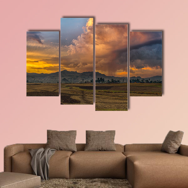 A rural landscape with stormy clouds emerging out of the mountains wall art