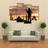 Armed terrorists near the mosque at sunset Multi Panel Canvas Wall Art