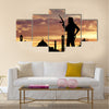 Armed terrorists near the mosque at sunset Multi Panel Canvas Wall Art