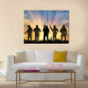 Armed terrorists near the city at sunset Multi Panel Canvas Wall Art