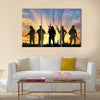 Armed terrorists near the city at sunset Multi Panel Canvas Wall Art