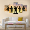 Armed terrorists near the city at sunset Multi Panel Canvas Wall Art