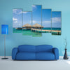 The Water Bungalows on the tropical lagoon in Maldives Multi Panel Canvas Wall Art