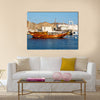 Old boat in the sidewalk near the sea in Oman multi panel canvas wall art