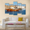 Old boat in the sidewalk near the sea in Oman multi panel canvas wall art