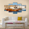 Old boat in the sidewalk near the sea in Oman multi panel canvas wall art