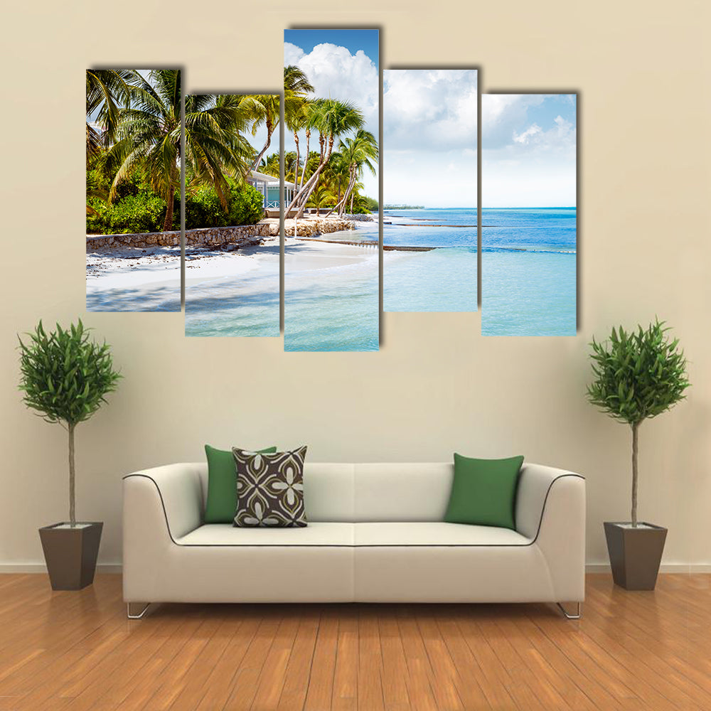 Beachfront bungalow on a tropical island Multi panel canvas wall art