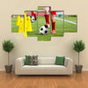 Soccer football players during the team training with ball and marker cones Multi panel canvas wall art