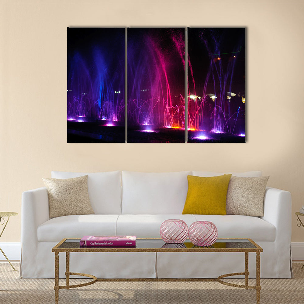 fountain in night illuminated red and blue colors multi panel canvas wall art