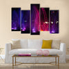 fountain in night illuminated red and blue colors multi panel canvas wall art