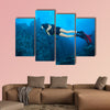 Young woman scuba diver exploring sea bottom. Underwater life with beautiful wall art