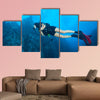 Young woman scuba diver exploring sea bottom. Underwater life with beautiful wall art