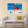 Kids in red Santa hats having fun at tropical beach during Christmas vacation Multi panel canvas wall art