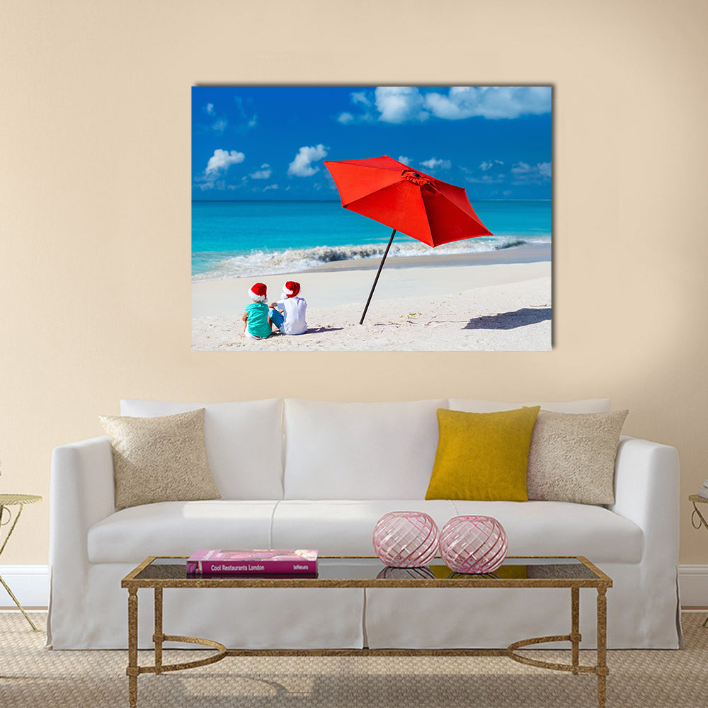 Kids in red Santa hats having fun at tropical beach during Christmas vacation Multi panel canvas wall art