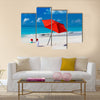 Kids in red Santa hats having fun at tropical beach during Christmas vacation Multi panel canvas wall art