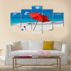 Kids in red Santa hats having fun at tropical beach during Christmas vacation Multi panel canvas wall art